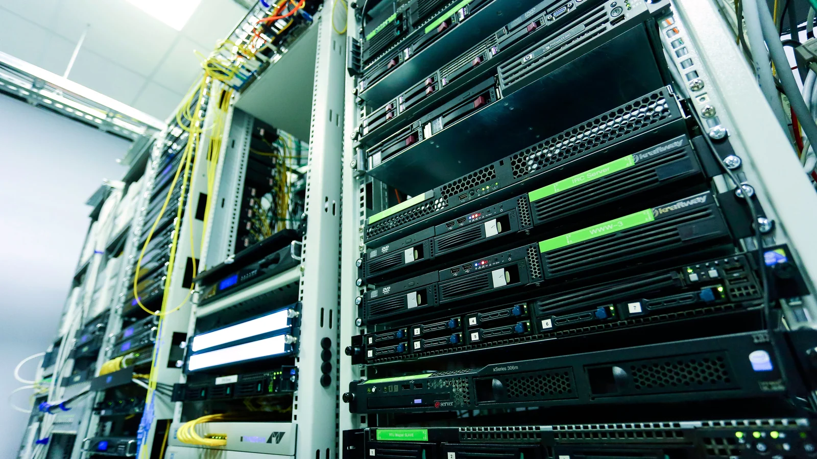 High-tech server rack in a secure data center with network cables and hardware components.